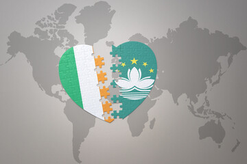 puzzle heart with the national flag of Macau and ireland on a world map background.Concept.