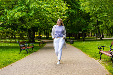 Beautiful woman walking in city park
