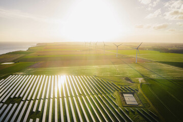 Wind turbines and solar panels farm in a field. Renewable green energy. Sunny landscape, electric energy generator for clean energy producing concept © Benoît