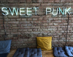 Relax under the Sweet Punk neon sign