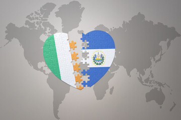 puzzle heart with the national flag of el salvador and ireland on a world map background.Concept.