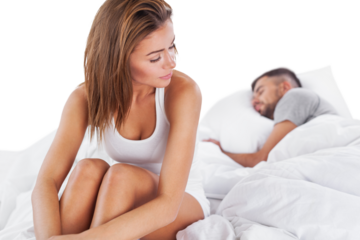 Portrait of unhappy young beautiful heterosexual couple in bedroom