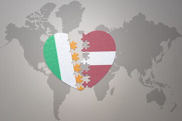 puzzle heart with the national flag of latvia and ireland on a world map background.Concept.