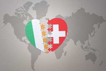 puzzle heart with the national flag of switzerland and ireland on a world map background.Concept.