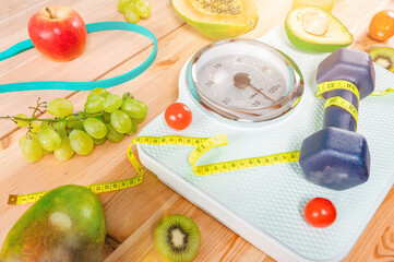 Fitness with dumbbell and genuine food with fresh fruit