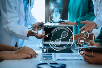 Medical technology network team meeting concept. Doctor hand working with smart phone modern digital tablet and laptop computer with graphics chart interface, with virtual icon diagram