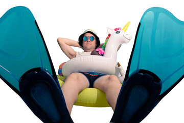 full shot, man equipped with unicorn float, mirrored glasses, beach cap, snorkel fins sitting on a large float and sunbathing © Lorena
