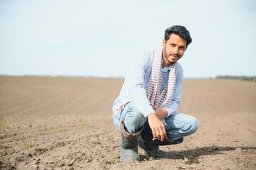 Naklejka na ściany i meble Young Indian farmer in his field