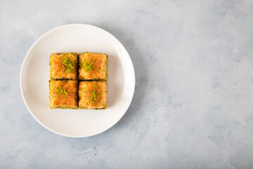 Pistachio Turkish baklava on a white plate,top view
