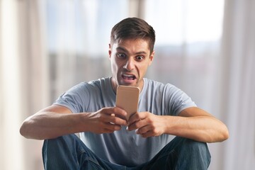 Application concept. Young smiling man hold phone