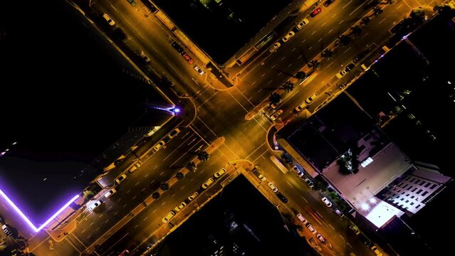 Cross, road and time lapse, aerial view at night with traffic, landscape and transportation with fast travel. Buildings, urban street with neon line, visual effects and drone with infrastructure