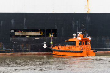 Pilot boat and cargo vessel at sea. Pilot embarkation. Pilotage.