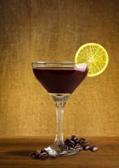 Tasty espresso coffee in glass with coffee beans