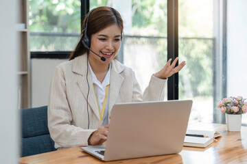 Call center agent with headset working on support hotline in modern office. Video conference