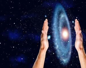 Cosmic Energy concept - male hands and night sky
