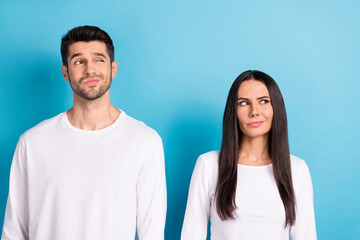 Photo portrait of cute young man woman look skeptical unsure empty space wear trendy white clothes isolated on blue color background