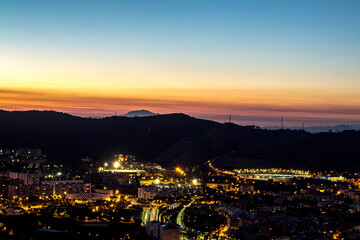 Night view of the city of Barcelona from a hill.