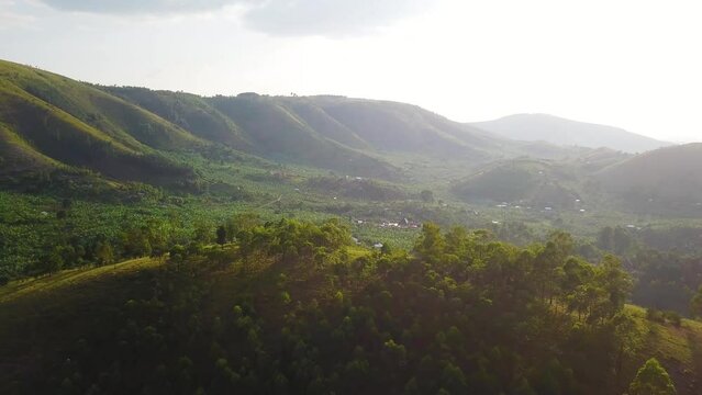 Aerial view passing over a hill to discover the paradise of Nyore Hillside in Mbarara, Uganda, on a sunny day. High quality 4k footage.