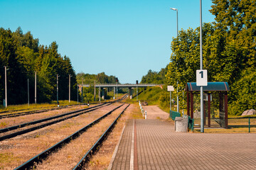 Platform of a train station with empty railway tracks