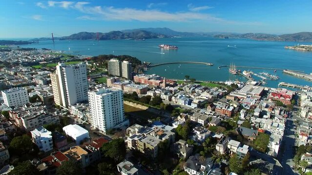 Aerial Shot Of Buildings In City Near Vessels On Sea Against Sky, Drone Flying Forward Over Cityscape On Sunny Day - San Francisco, California