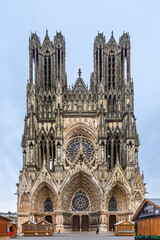 Fototapeta na wymiar Facade with towers and portals of Reims Cathedral, France