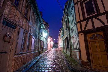 Fototapeta na wymiar Cobblestone street with Medieval Half-Timbered houses in Beauvais France at night