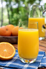 Glass of orange juice outdoors on a table