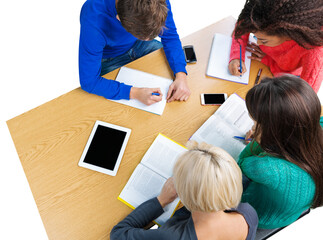 Group of young students studying together at desk