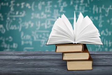 Math geometry formulas and books on board background