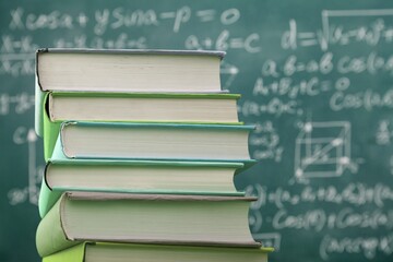 Math geometry formulas and books on board background