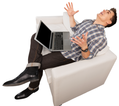 A concentrated young man works on a laptop computer