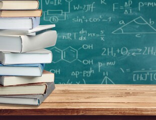 Math geometry formulas and books on board background