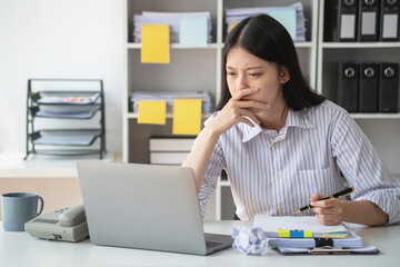 Fototapeta na wymiar Concept Burnout Syndrome. Asian business Woman feels uncomfortable working. Which is caused by stress, accumulated from unsuccessful work And less resting body. Consult a specialist psychiatrist.