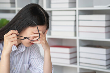 Concept Burnout Syndrome. Asian business Woman feels uncomfortable working. Which is caused by...