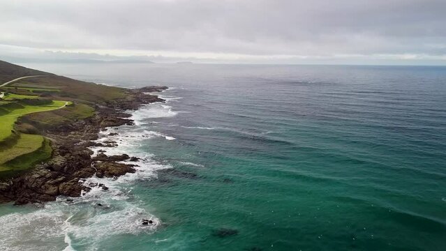 Tranquility Scene Of Ocean Waves Gently Splashing On Rocky Shore Of Caion On A Cloudy Day In Coru&ntilde;a, Spain. aerial