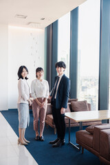 Fototapeta premium オフィスで仲良く話す若いビジネスパーソン