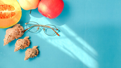 Summer blue banner with fruits, glasses and sea shells. Summer vacation background composition