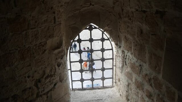 A View Through a Latticed Antique Window at the Pedestrians Below