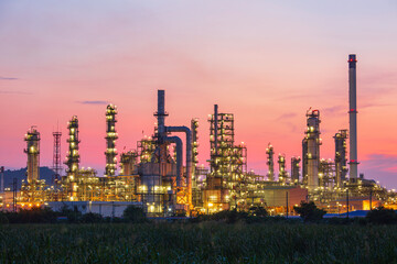 Obraz na płótnie Canvas Oil​ refinery​ and​ plant and tower column of Petrochemistry industry in oil​ and​ gas​ ​industrial with​ cloud​ red sky
