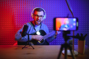 Male vlogger recording music related broadcast at studio