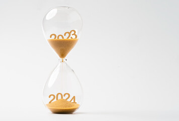 Sand inside of hourglass of change year from 2023 to 2024 for countdown of merry Christmas.and happy new year concept.