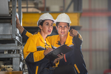 Factory apprenticeship. Man mentor teaching Female employees trainee operating machine looking...