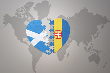 puzzle heart with the national flag of madeira and scotland on a world map background.Concept.