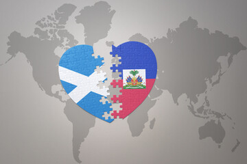 puzzle heart with the national flag of haiti and scotland on a world map background.Concept.