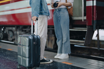 Tourist couples showing their love and happiness in a sweet way while waiting for their journey at the train station.