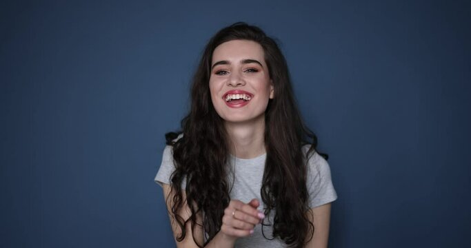 Young happy woman on blue background