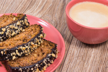 Fresh pastry made of zucchini and cup of white coffee. Delicious dessert. Wooden background