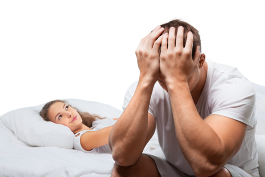 Sad mature couple lying on bed