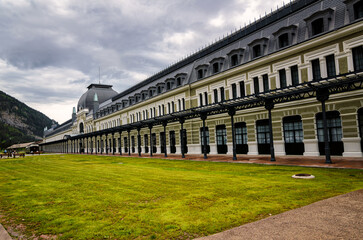Fototapeta premium Canfranc Station, Spain, is a historic railway station known for its grandeur and architectural beauty. With its ornate facade and sprawling size, it stands as a symbol of a bygone era of luxury and 