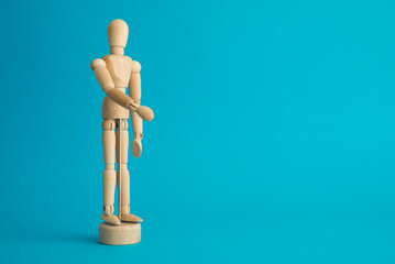 Wooden man figure on blue background copy space. Human resource (HR) in business company, headhunter recruitment, job interview and course training development skill concept.